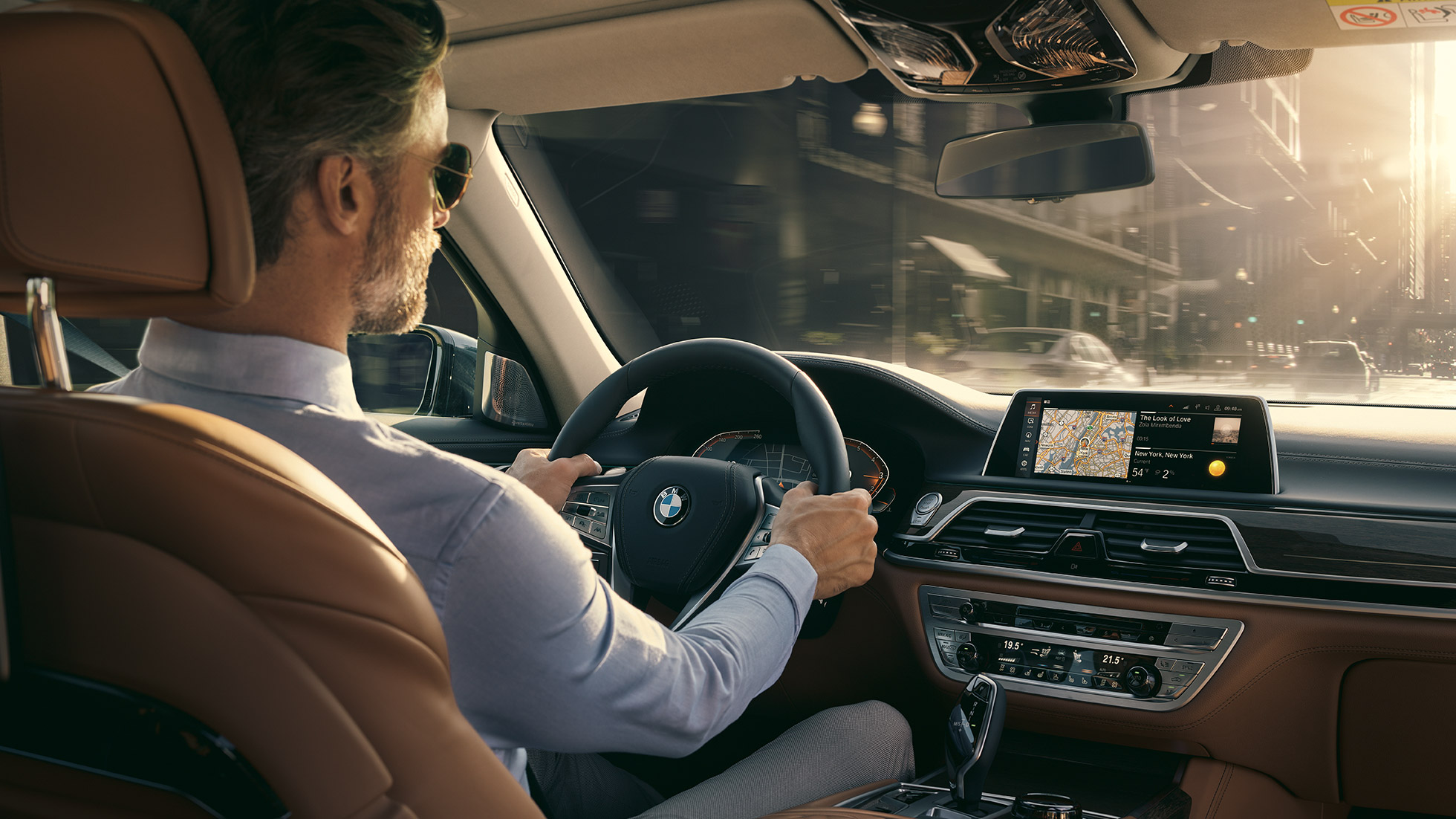 Fonctionnalités Connectivity de la BMW Série 7 BMW Série 7 Berline : homme assis à bord de la BMW en train d’utiliser les fonctionnalités Connectivity